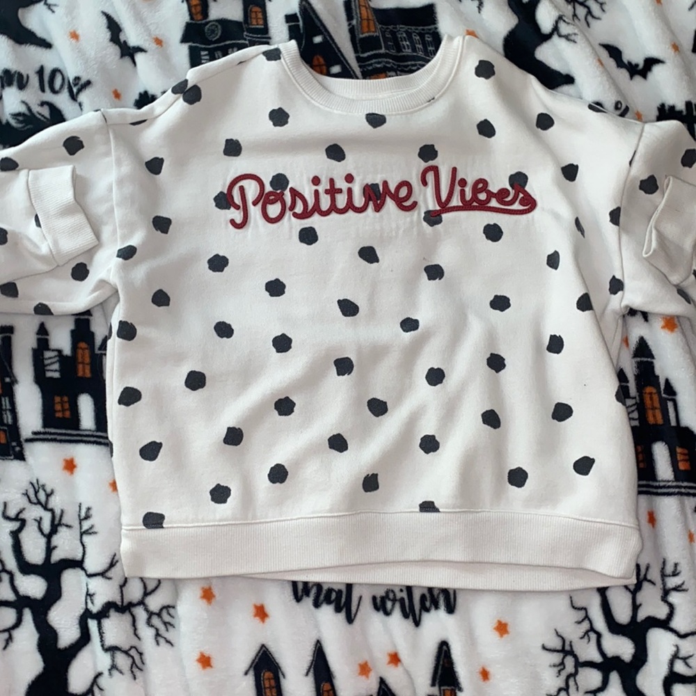 This is a black and white poka dot shirt with no holes, rips,or stains.